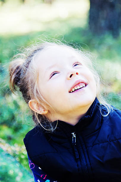 istock Girl looking up and smiling 486818960