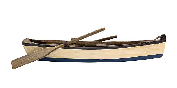 Wooden little boat Isolated wooden boat with paddles rowboat stock pictures, royalty-free photos & images