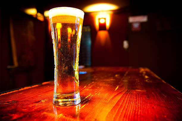 istock Glass of beer on a dark pub 486820696