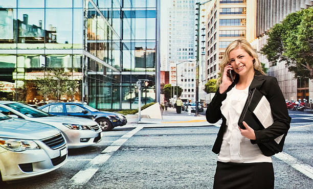 istock Smiling businesswoman outdoors and on mobile 486820906