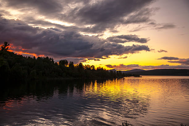 istock Sunset over a calm lake with ripples in the water. 486821476