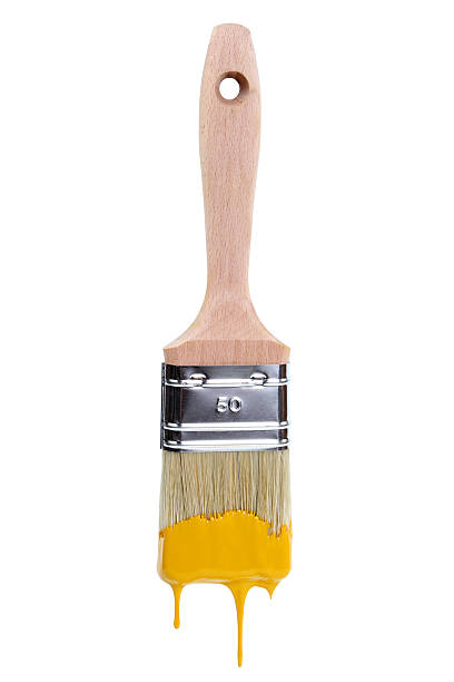 Paintbrush Paintbrush with dripping yellow paint isolated over white background paintbrush stock pictures, royalty-free photos & images