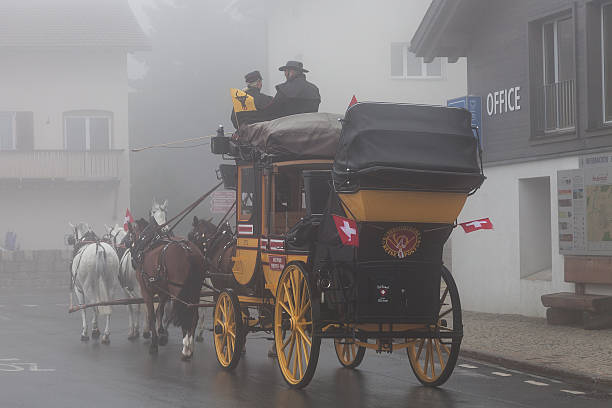 Gotthard stagecoach Andermatt, Switzerland - August 1, 2015: Historical Gotthard stagecoach during the start of the journey in Andermatt.  The legendary horse-drawn mail coach starts its journey in Andermatt (Uri Canton) and drives to Airolo (Ticino) via the Gotthard pass. gotthard pass stock pictures, royalty-free photos & images