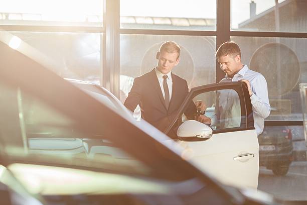 istock Businessman watching car in showroom 486822710