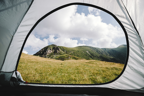 look out of the tent in the mountains. outdoor tent and hills. England or the Alps