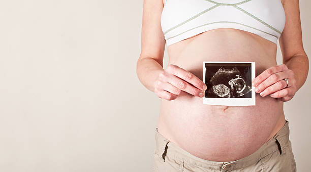 istock Pregnant woman holding an ultrsound scan 486825472