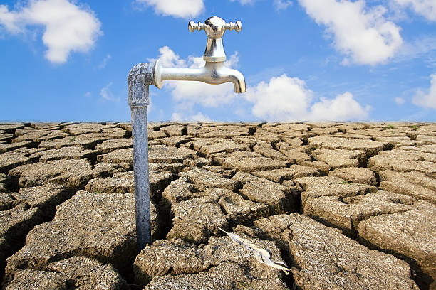 istock Water Faucet on Dry Soil Texture 486825526