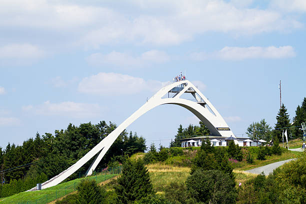 Ski flying of Winterberg Winterberg, Germany - August 22, 2015: Distance shot of ski flying in Winterberg in summertime. Some people and tourists are on top of sky flying. winterberg photos stock pictures, royalty-free photos & images