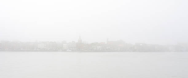 Old City skyline in the mist Old European City of Dordrecht on the river merwede with its skyline in the mist dordrecht stock pictures, royalty-free photos & images