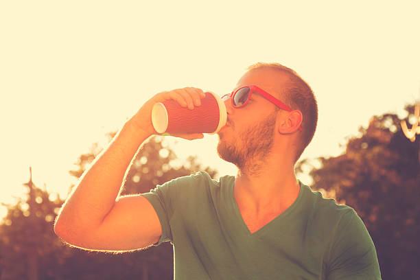 istock Young man drinking coffee outdoors. 486826956