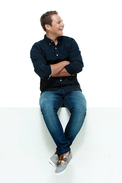 istock Smiling casual male on box and looking away 486828252