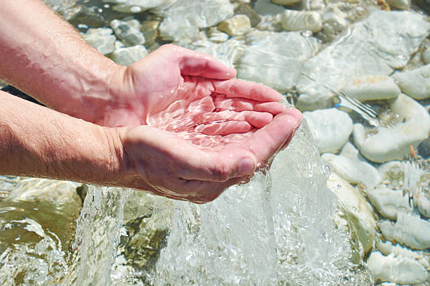istock Sea water in palms of man 486829196