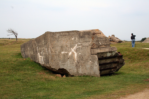 Point du Hoc, France - July 27, 2006: The famous D-Day site at Point du Hoc where the U.S. Rangers scaled the 100 foot cliff and took the fortified position. The area was heavily bombarded ahead of time, as seen by the craters and damage that exist up to today.