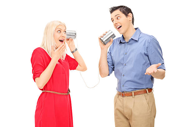 istock Man and woman talking through a tin can phone 486832263