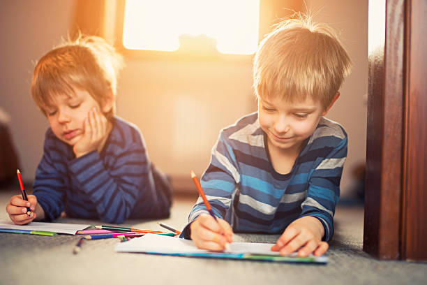 istock Little brothers enjoying drawing on the floor 486832270