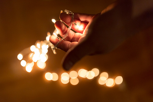 Close up image of male hands holding lights