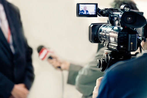 TV Media Interview - Journalist interviewing businessman or politician, camera recording