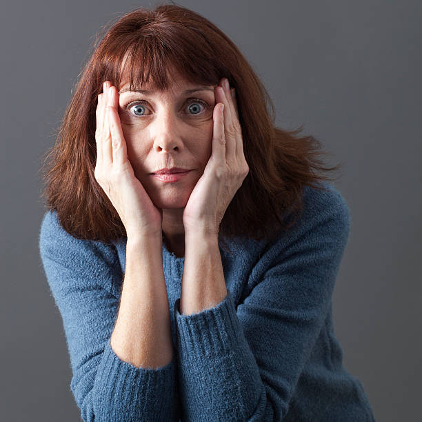 istock speechless 50s woman expressing surprise and fear 486833242