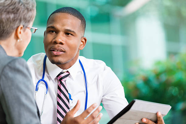 istock Doctor meeting with senior patient, using digital tablet 486834242