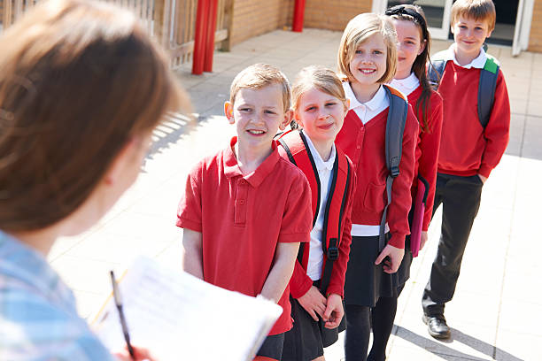 Portrait Of Diverse Elementary Student In Uniform Smiling And Pose At Camera