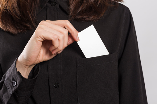 Cropped view of a businesswoman pulling an ace card out of his pocket.