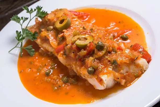 filet of fish cooked Veracruzana style with onions, capers, tomatoes, and olives