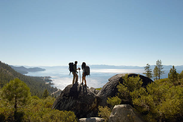 istock Hiking Couple Standing On Rock At Coast 486836721