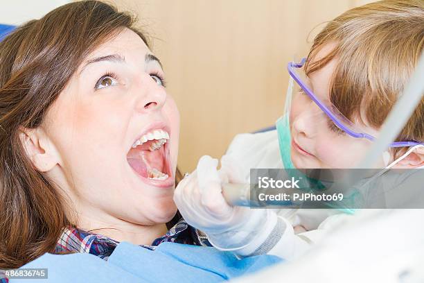 Little Dentist With Scared Patient Stock Photo - Download Image Now - 2-3 Years, 20-24 Years, Adult