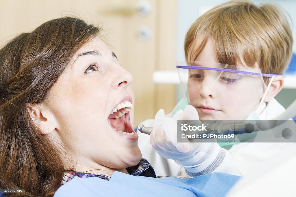 Little Dentist with scared patient Toddler Dentist with scared patient - Young professionist 2-3 Years Stock Photo