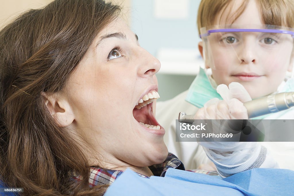 Little Dentist with scared patient Toddler Dentist with scared patient - Young professionist 2-3 Years Stock Photo