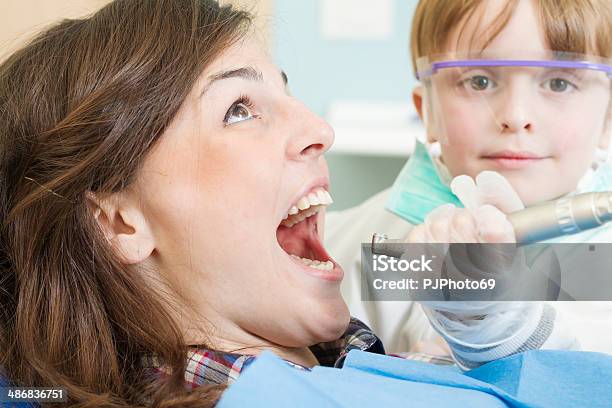 Little Dentist With Scared Patient Stock Photo - Download Image Now - 2-3 Years, 20-24 Years, Adult