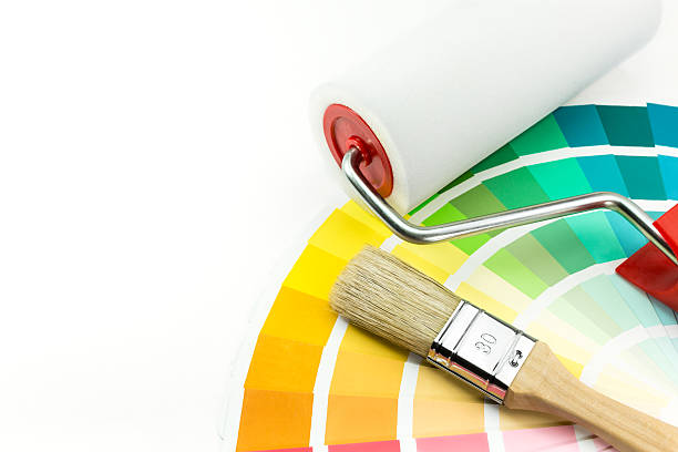 istock Paint roller and brush over color swatches 486837599