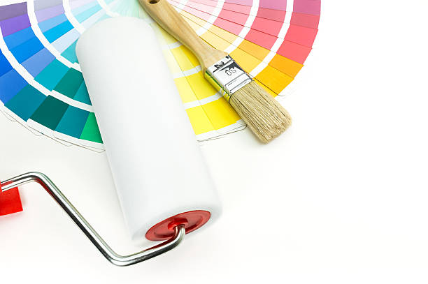 istock Paint roller and brush on palette of colors 486837683
