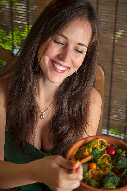 istock Happy girl holding raw vegan casserole. 486839498