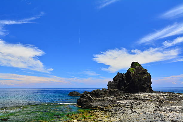 istock Jagged rocks and blue sky at seashore 486840934