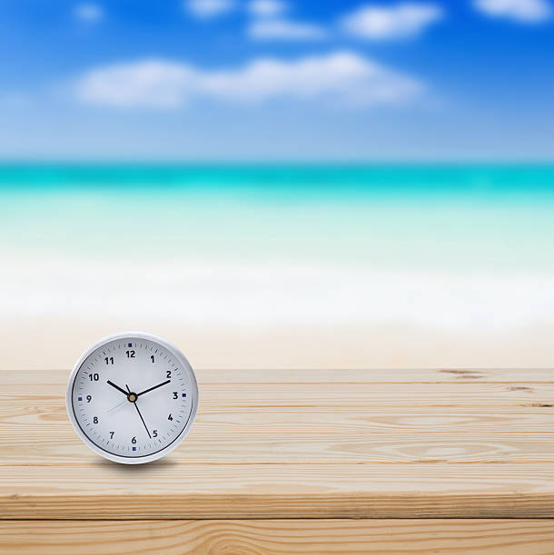 istock Clock on wood table and blue sea background 486841654