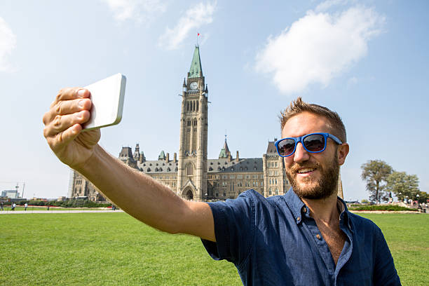 istock One man taking selfie portrait at Ottawa parliament 486841680
