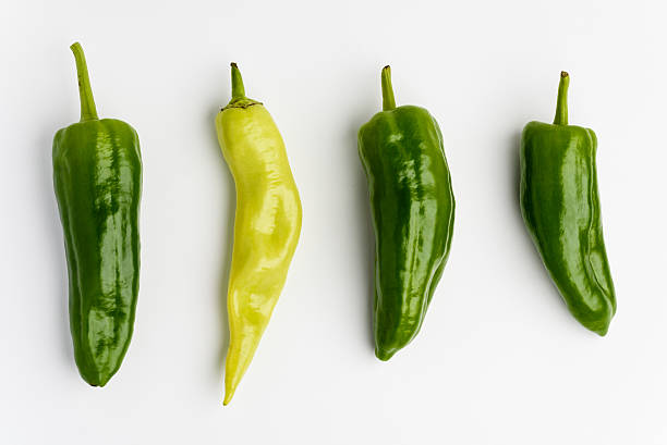 Green and yellow peppers on white background stock photo