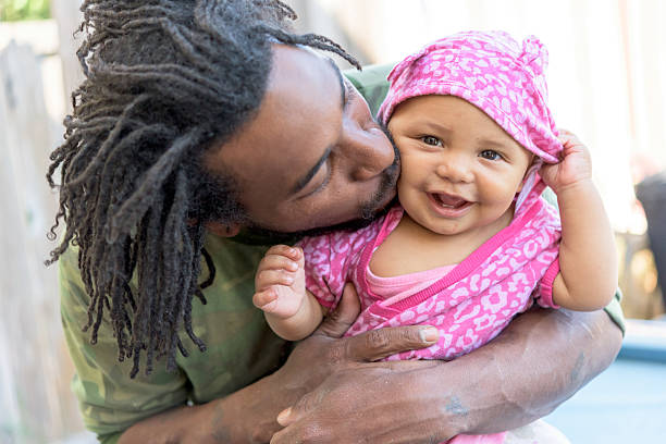 Father and Daughter African american man posing posing holding his baby daughter caribbean culture stock pictures, royalty-free photos & images