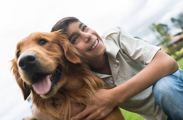 istock Boy with a dog at the park 486843540