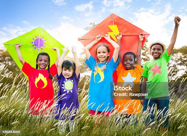 Kids Diverse Playing Kite Field Young Concept Stock Photo - Download Image Now - 2015, African Ethnicity, Asian and Indian Ethnicities