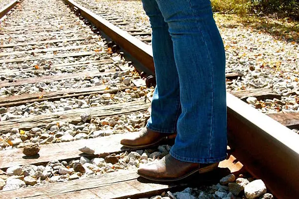 Boot cut jeans, cowboy boots, train tracks