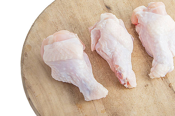 istock raw chicken legs on wooden cutting boards on white background 486850456