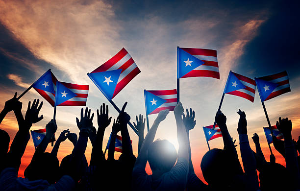 istock Group People Waving Flag Puerto Rico Back Lit 486850750