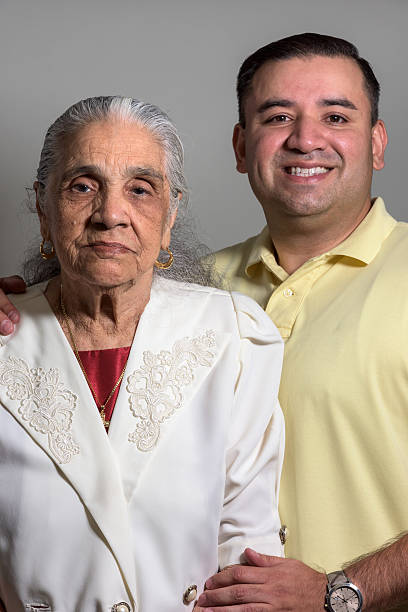 Hispanic grandmother and grandson Hispanic grandmother and grandson posing together grandmother real people front view head and shoulders stock pictures, royalty-free photos & images