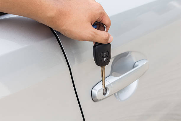 istock Man holding car key at new car 486853958