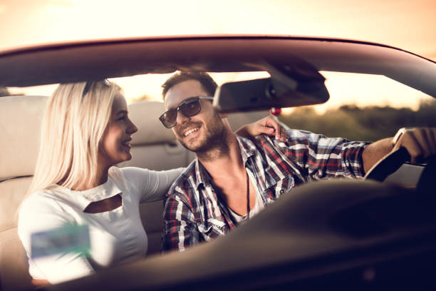 istock Embraced couple on a road trip in convertible car. 486854632
