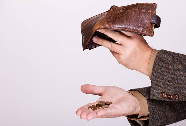 istock Broke businessman with empty wallet and polish coins 486855857