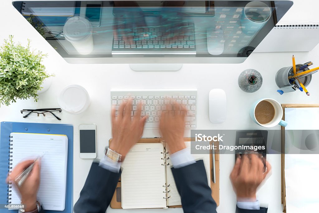 All day long Hands of business person working at his table, blurred motion Multi-Tasking Stock Photo