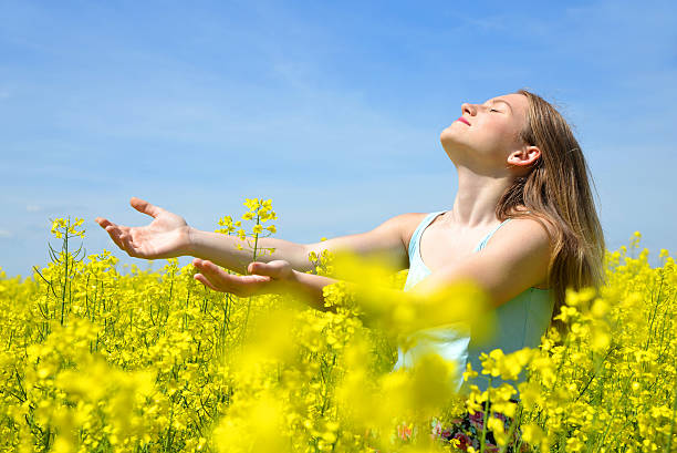 istock Young happy woman on blooming rapeseed field 486858230